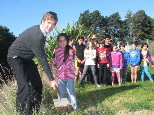 Council's Paul Murphy gives Elise Sadlier from Room 2 at Awapuni School some tips on how to plant on the side of streams while teacher Cheryl Gomm and her class mates look on. Room 2 are preparing for a school planting day at 9am on Friday and a community
